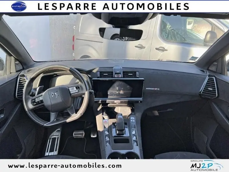 Vue intérieure avant du DS7 Crossback gris 2021, tableau de bord moderne avec écran tactile central et volant multifonction.