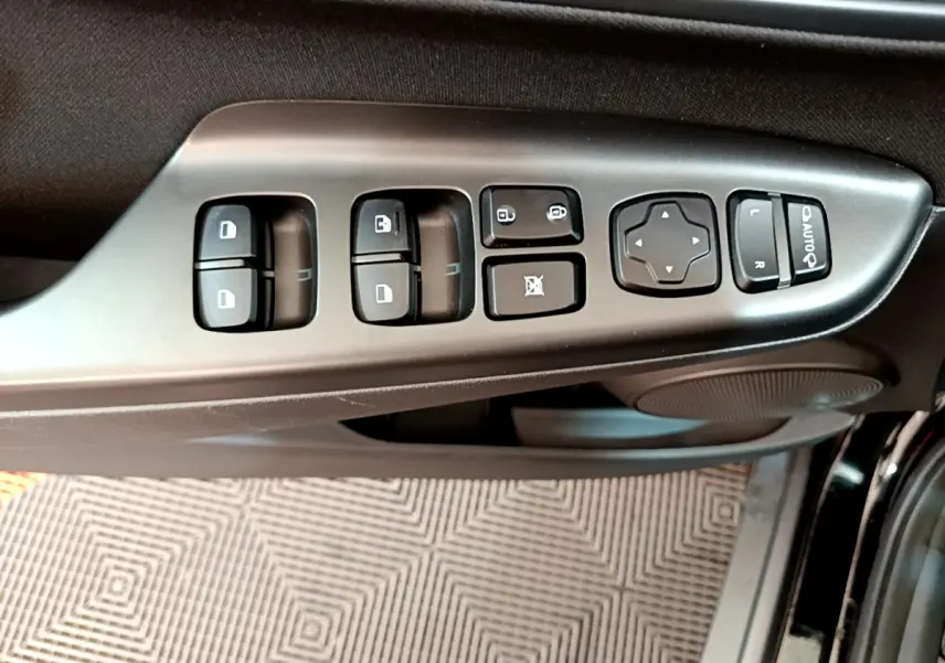 Gros plan sur les commandes de vitres et rétroviseurs côté conducteur du Hyundai Kona noir 2020.