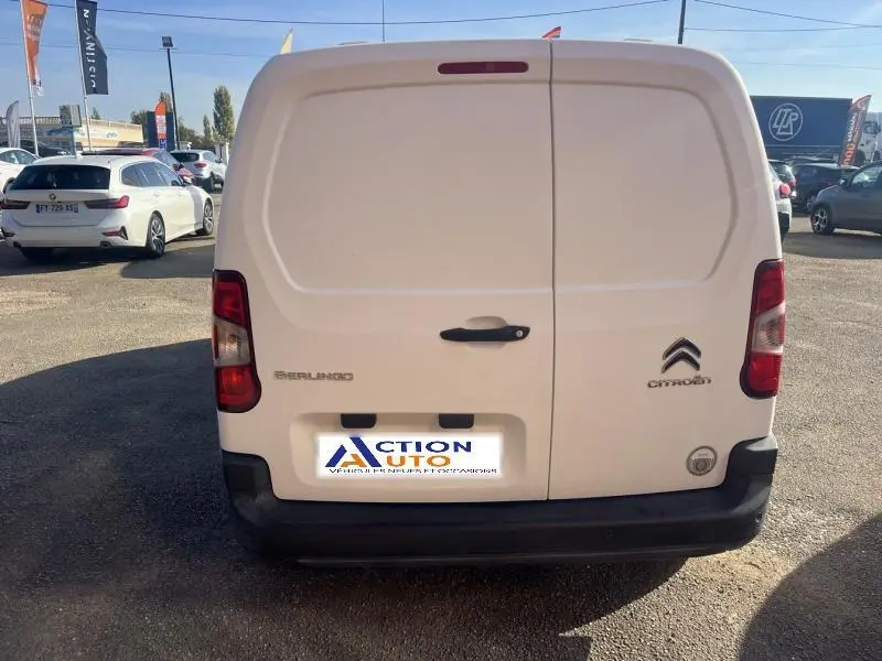 Vue arrière d'un utilitaire Citroën Berlingo blanc Banquise avec portes battantes et logo visible.