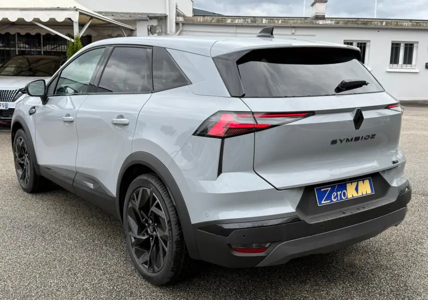 Vue 3/4 arrière droite du Renault Symbioz gris Rafale avec feux arrière LED et jantes noires distinctives.