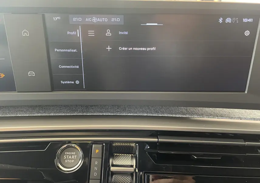 Vue rapprochée du tableau de bord du Peugeot 3008 noir 2025, avec écran tactile et bouton démarrage moteur.