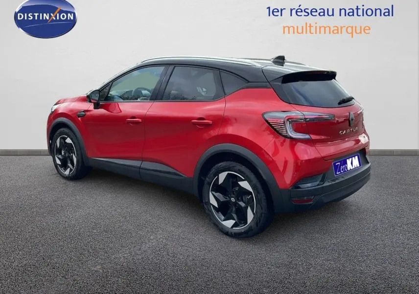 Vue 3/4 arrière droite d'un Renault Captur E-Tech hybride rouge passion avec toit noir et jantes noires.