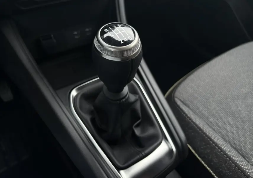 Le levier de vitesses manuel noir du Renault Captur 2025, avec pommeau argenté et coutures visibles.