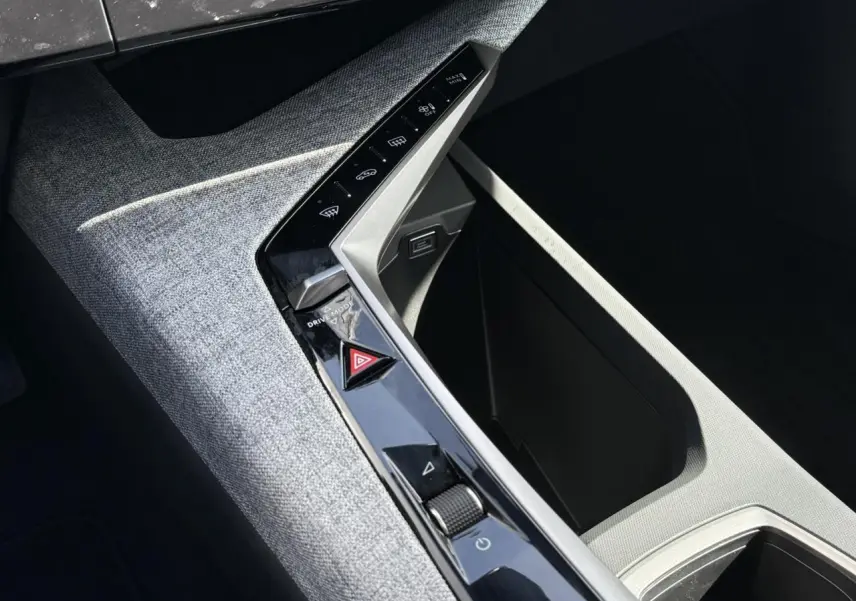 Détail de la console centrale grise avec commandes tactiles et molette du Peugeot 3008 Hybrid 145 e-DSC6 Allure 2025.