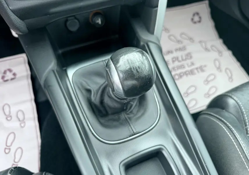 Gros plan sur le levier de vitesses manuel noir de la Citroën DS4, entouré de la console centrale et tapis de sol.