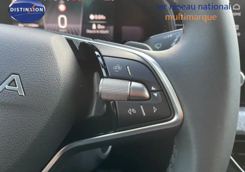 Gros plan sur les commandes au volant en cuir noir du Skoda Kamiq gris argent, avec molette et boutons multifonctions.