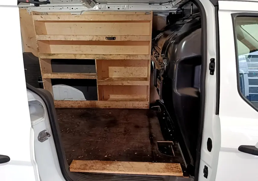 Vue intérieure arrière du Ford Transit Fourgon blanc 2022, montrant l’espace de chargement avec étagères en bois.