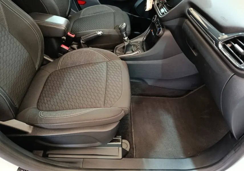 Vue intérieure côté passager avant du Ford Puma 2022, sièges noirs et console centrale avec levier de vitesses manuel.