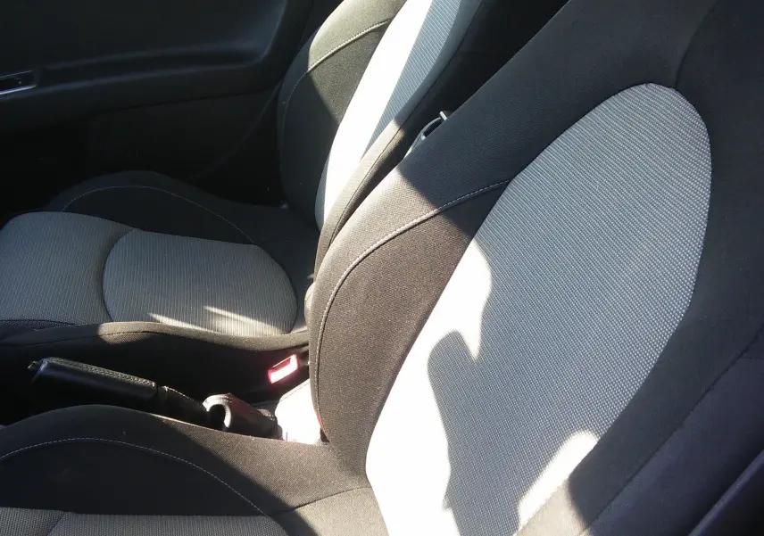 Gros plan sur les sièges avant noirs et gris de l'Alfa Romeo MiTo Distinctive 2010, intérieur sobre et fonctionnel.