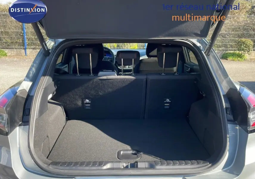 Coffre ouvert vu de l’arrière d’un Ford Puma gris Solar Metal, montrant l’espace de chargement et les sièges arrière.