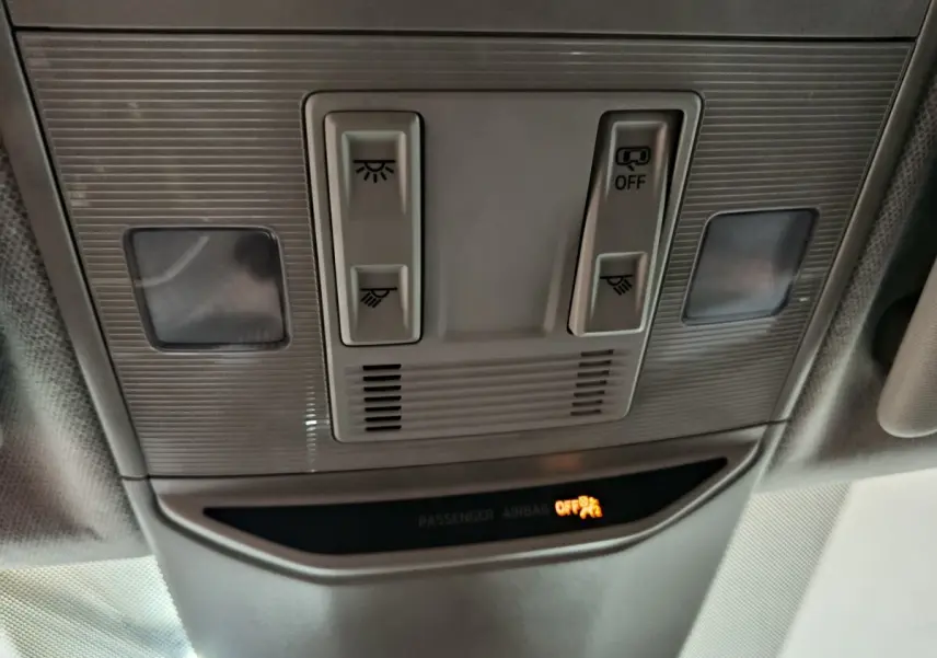 Vue en gros plan du plafonnier gris clair avec commandes d’éclairage et témoin airbag passager désactivé.