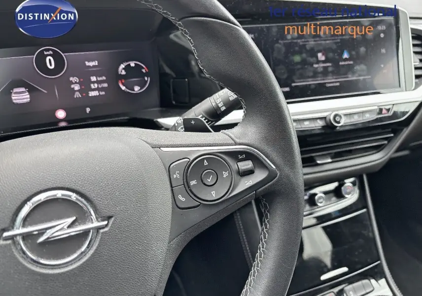 Gros plan sur le volant en cuir noir et le tableau de bord numérique de l'Opel Grandland 2023, finition Business Elegance.