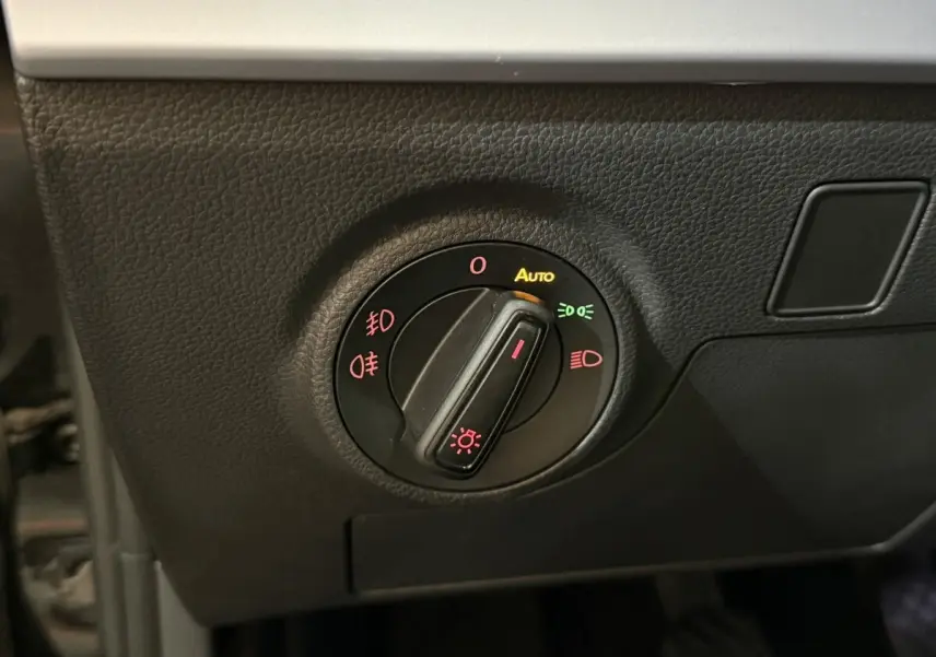 Gros plan sur le bouton de commande des phares dans l’habitacle noir du SEAT Ibiza 1.0 TSI 110 FR 2024.