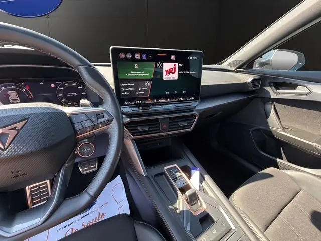 Vue intérieure côté conducteur du tableau de bord et écran tactile central du CUPRA Formentor blanc 2025.