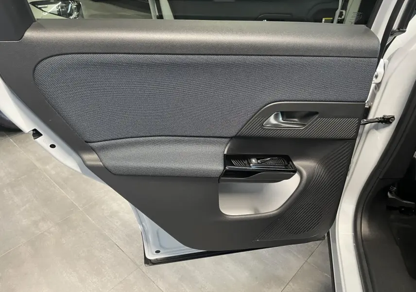Vue rapprochée de la porte arrière droite blanche du Citroën C5 Aircross 2026 avec habillage noir texturé et poignée intégrée.