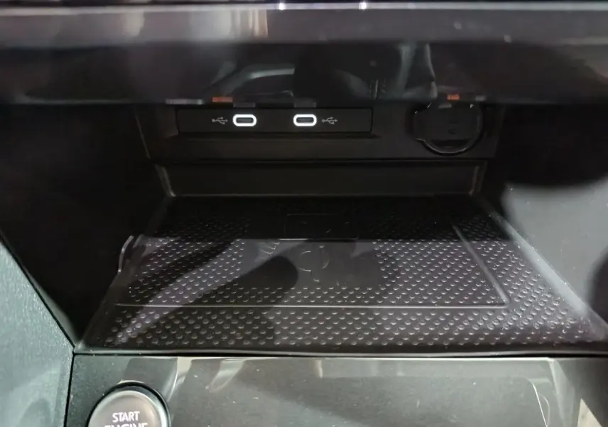 Gros plan sur la console centrale du Volkswagen Tiguan 2021, montrant ports USB, prise 12V et bouton démarrage.