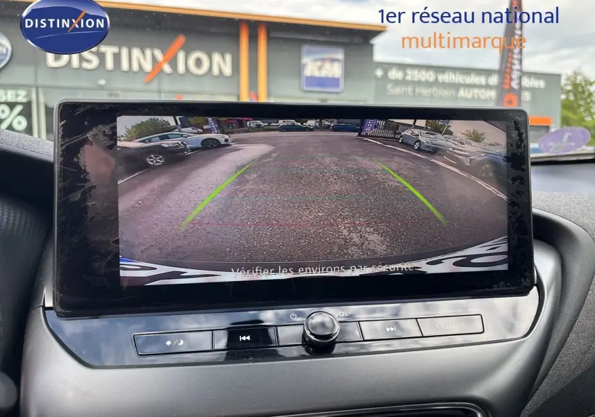 Écran central montrant la caméra de recul d’un Nissan Juke Hybrid gris squale metal, vue intérieure avant.