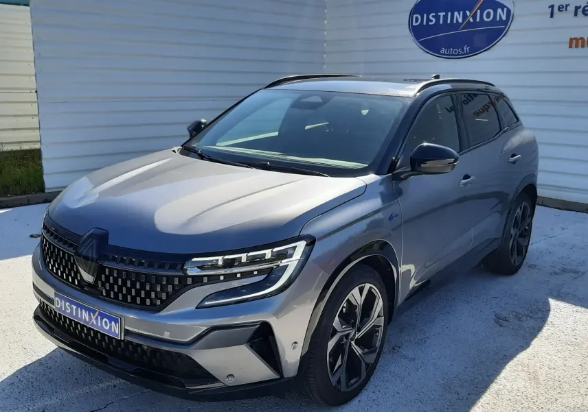 Renault Austral E-Tech hybride gris schiste avec toit noir, vue 3/4 avant droit, calandre et jantes distinctives.
