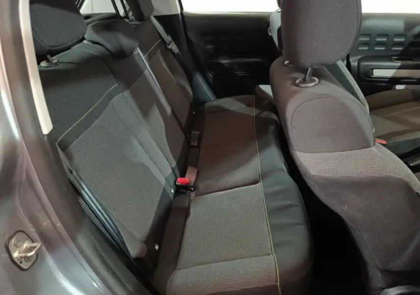 Vue intérieure côté gauche montrant la banquette arrière noire de la Citroën C3 gris clair 2024.