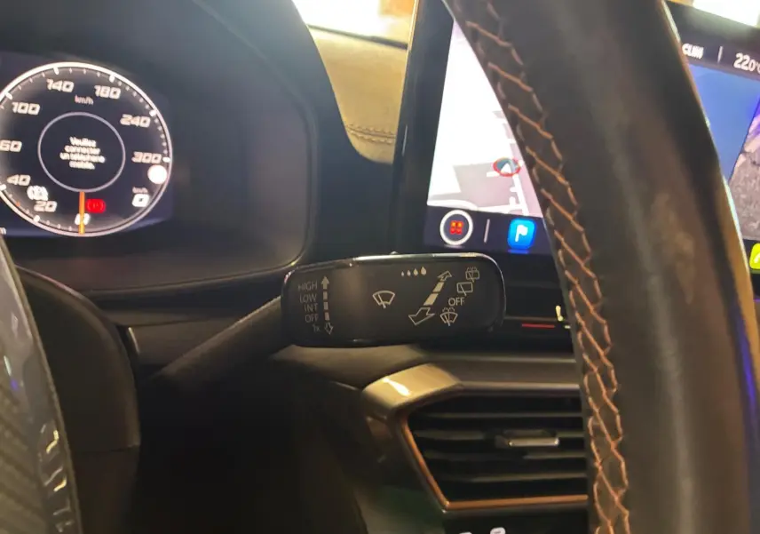 Vue intérieure rapprochée du volant et du combiné d'instruments du CUPRA Formentor 2.0 TDI noir avec commandes au volant et écran tactile.