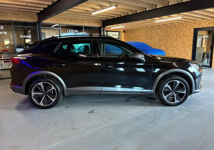 Vue de profil côté gauche d'un CUPRA Formentor noir 2022 avec jantes alu et entourage de vitres noir piano.