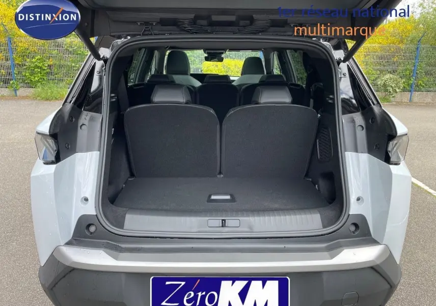 Vue arrière ouverte du Peugeot 5008 blanc Okenite métal avec toit noir, montrant l'espace de coffre et les sièges arrière.