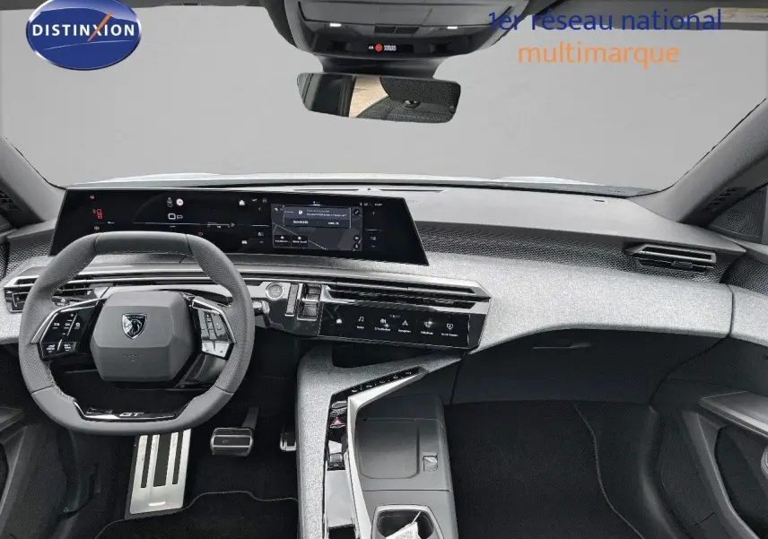 Intérieur moderne du Peugeot 5008 Hybrid 2025, vue frontale du tableau de bord et volant compact noir.