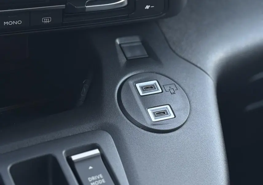 Gros plan sur les ports USB-C et bouton Drive Mode dans l'habitacle noir du Citroën Berlingo Multispace 2025.