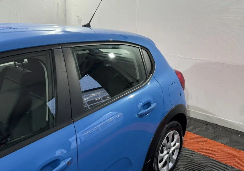 Vue côté droit arrière d'une Citroën C3 bleu vif avec poignées de porte et jante alliage visibles.