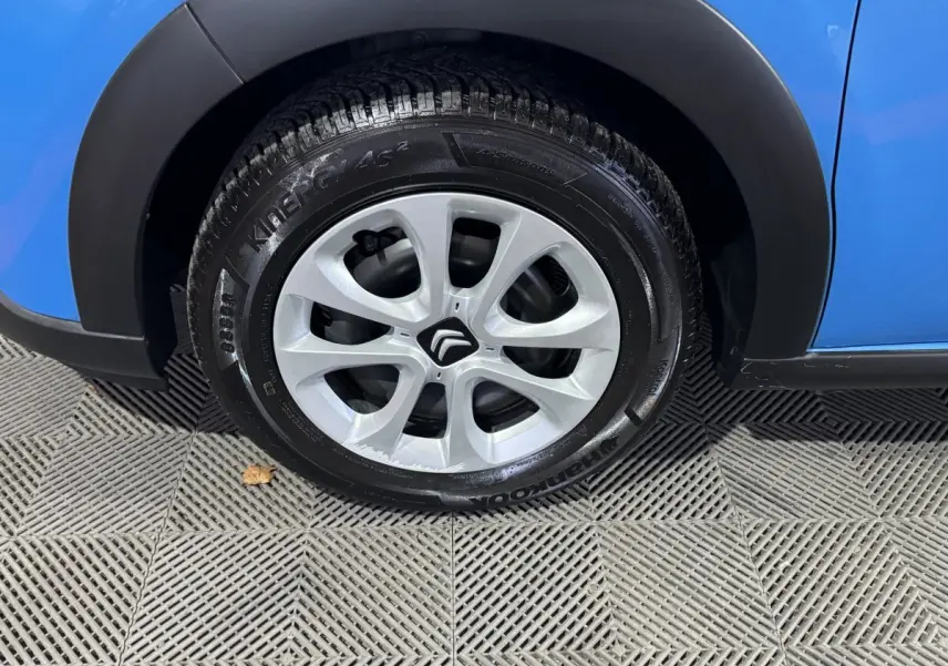 Gros plan sur la roue avant droite d'une Citroën C3 bleu 2018 avec jante en alliage et pneumatique Hankook.