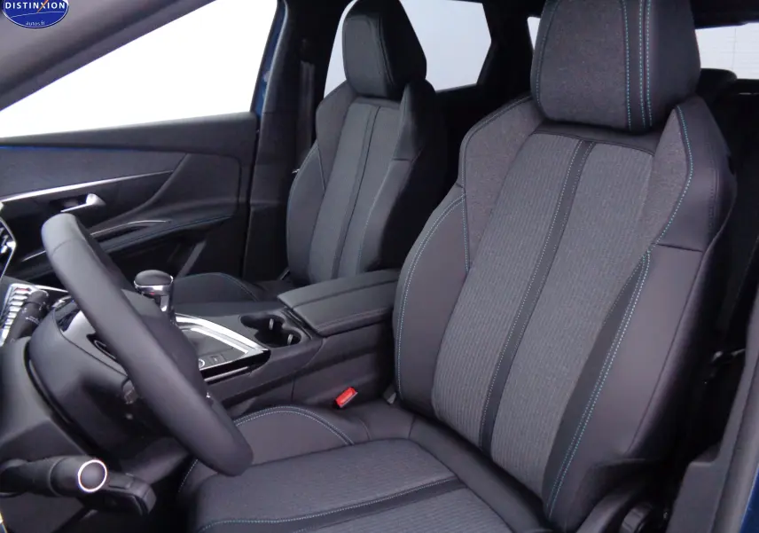 Vue intérieure côté conducteur du Peugeot 3008 2023 avec sièges en cuir noir et tissu gris à surpiqûres bleues.