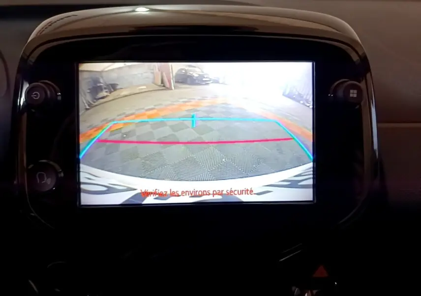 Écran tactile central montrant la caméra de recul d'une Citroën C1 gris clair, vue intérieure du tableau de bord.