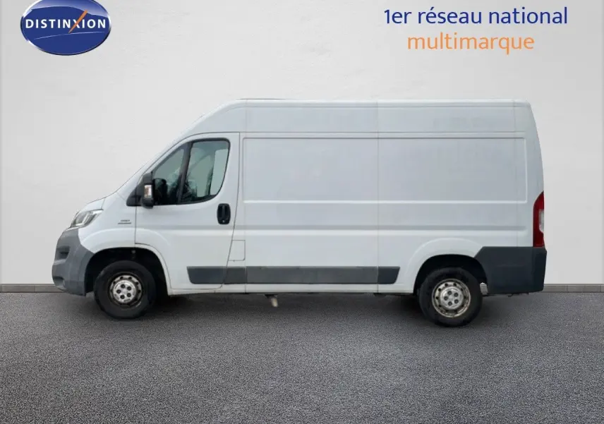 Vue de profil côté gauche d’un FIAT Ducato Fourgon blanc de 2014 avec bas de caisse et pare-chocs noirs.