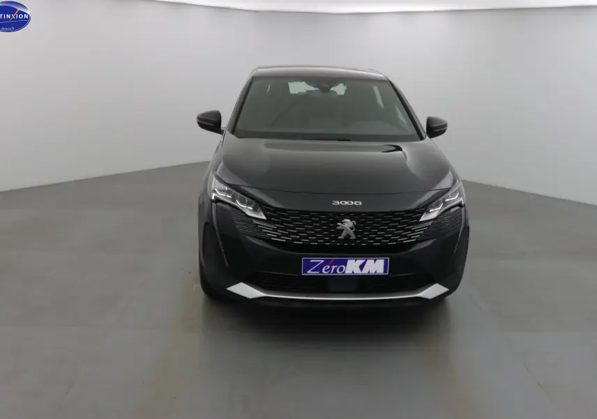 Vue frontale d'un Peugeot 3008 noir perle métal 2023 avec calandre distinctive et phares LED allumés.