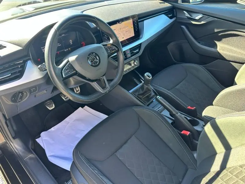 Intérieur noir du Skoda Kamiq 2020 vue côté conducteur, avec tableau de bord digital et levier de vitesse manuel.