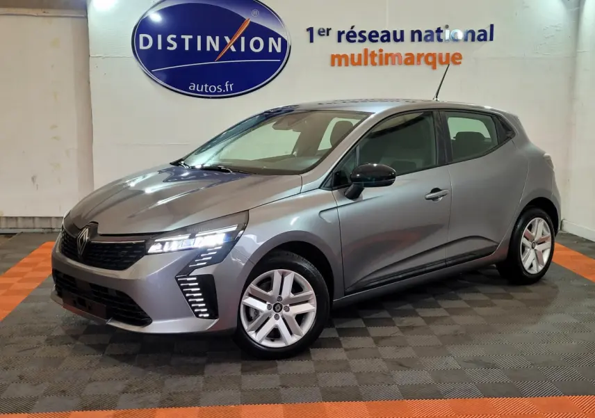 Renault Clio Evolution Blue dCi 100 gris foncé vue 3/4 avant avec feux LED et jantes alliage en intérieur showroom.