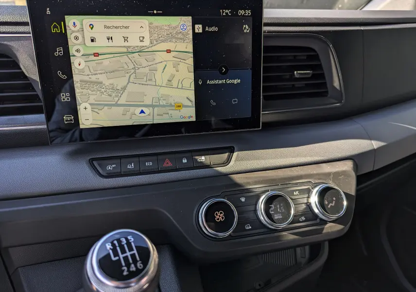 Tableau de bord du Renault Master 2025 avec écran tactile affichant la navigation et levier de vitesses manuel en premier plan.