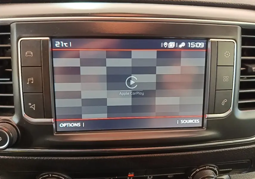 Écran tactile central affichant Apple CarPlay dans l'habitacle du Citroën Jumpy XS blanc, vue de face.