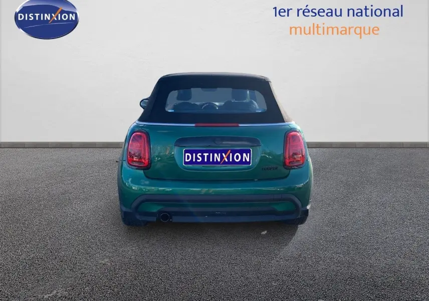 Vue arrière d'une MINI Cabriolet F57 1.5 136CH en British Racing Green avec capote noire fermée.