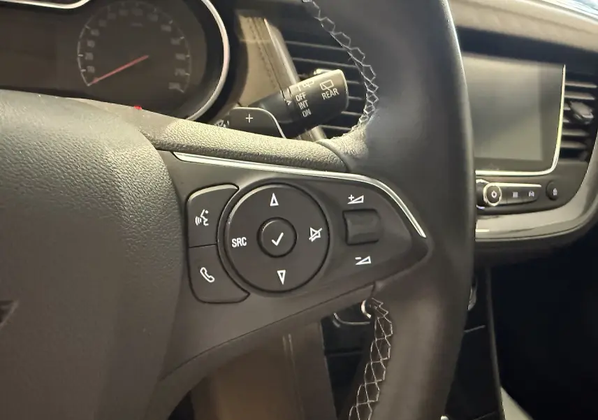Gros plan sur le volant gauche en cuir avec commandes intégrées et tableau de bord de l'Opel Grandland X 2021.
