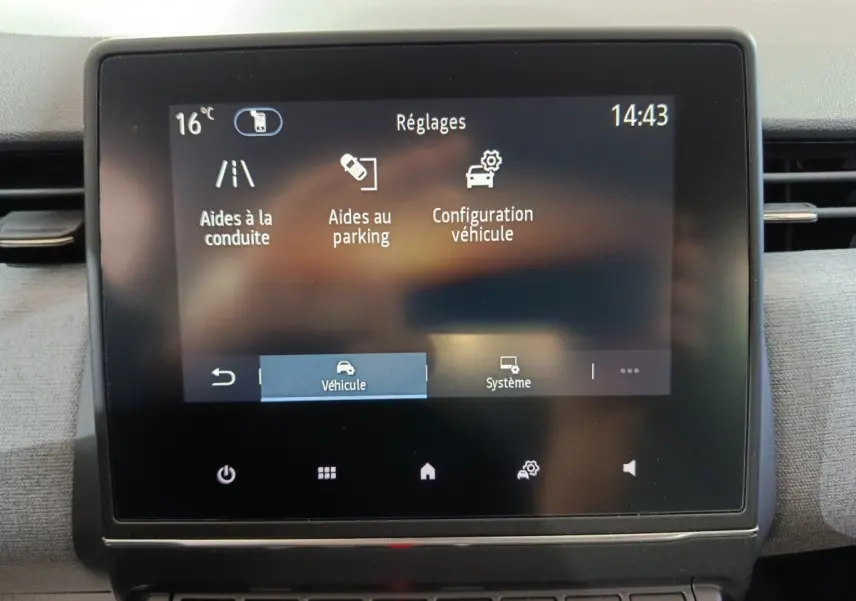 Écran tactile central affichant les réglages d’aide à la conduite et au parking dans une Renault Clio gris clair, vue intérieure.