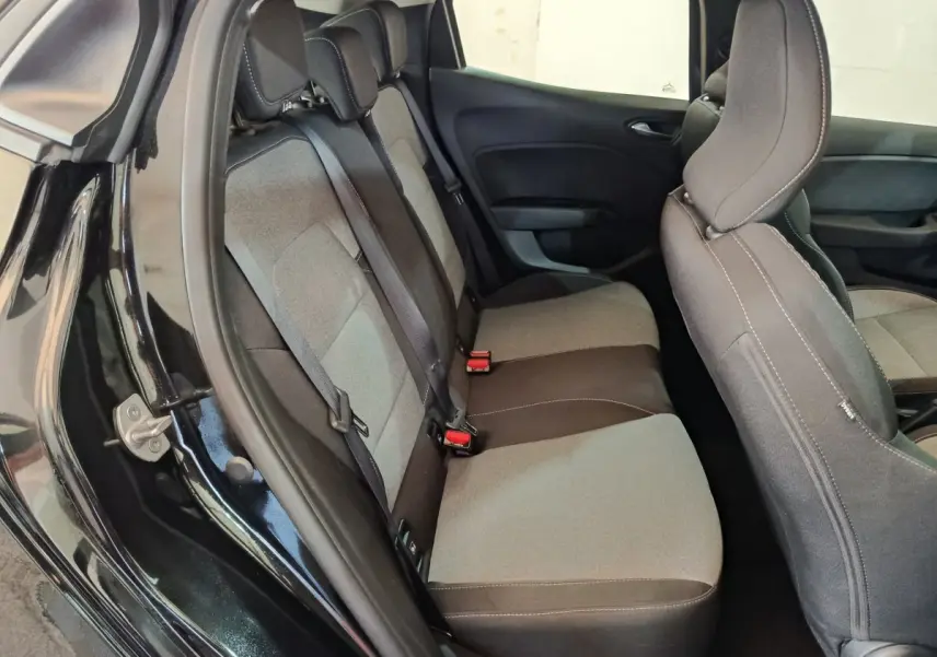 Vue intérieure côté gauche montrant la banquette arrière grise et noire de la Renault Clio noire 2025.