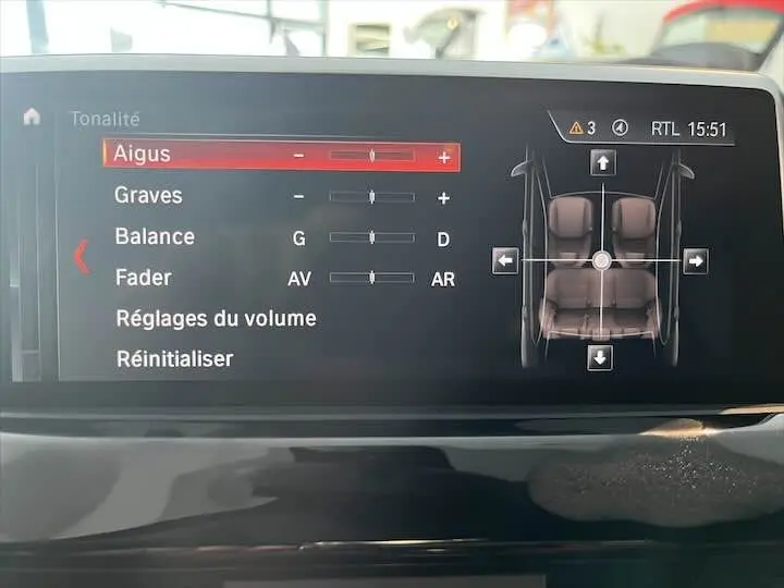 Écran central du BMW X2 noir métal 2022 montrant les réglages audio avec visualisation des sièges en vue intérieure.