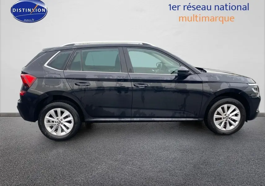 Vue de profil côté gauche d'un Skoda Kamiq noir 2025 avec jantes alu et barres de toit visibles.