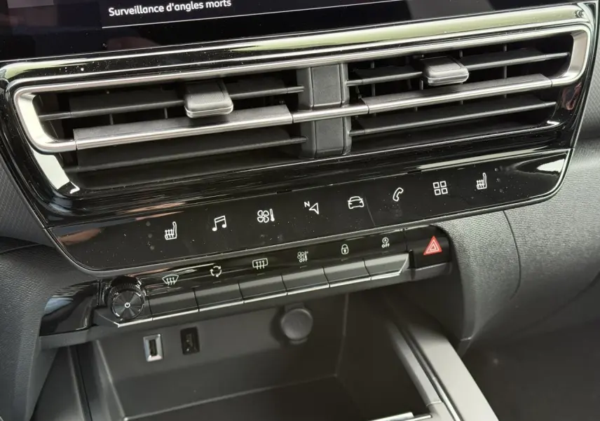 Détail de la console centrale noire du Citroën C5 Aircross Hybrid 2025 avec commandes tactiles et aérateurs horizontaux.