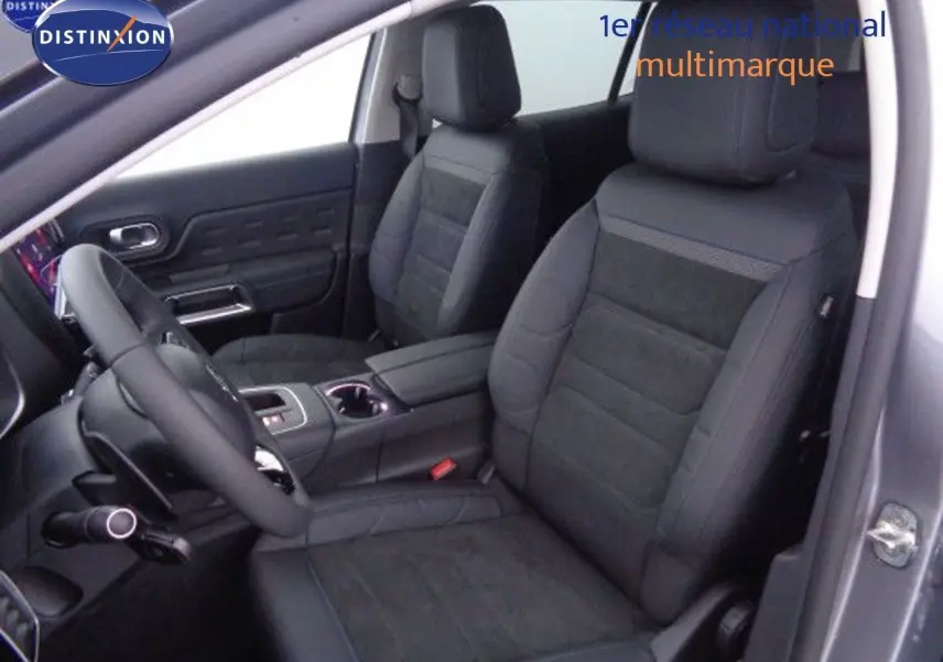 Intérieur avant du Citroën C5 Aircross 2022 gris, sièges en cuir et alcantara noirs avec console centrale visible.