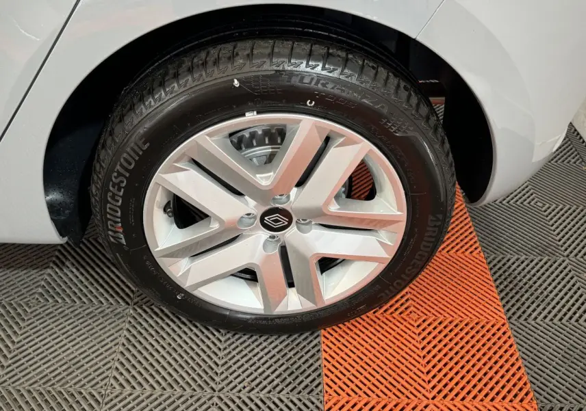 Gros plan sur la roue avant droite d'une Renault Clio gris clair, avec jante alliage et pneu Bridgestone.