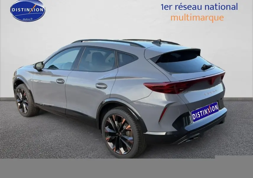 Vue 3/4 arrière droite d’un CUPRA Formentor gris graphene avec jantes noires et détails cuivrés, vitres arrière surteintées.