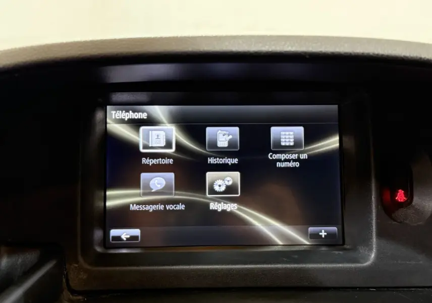 Écran tactile central du tableau de bord du Renault Kangoo blanc, affichant le menu téléphone avec plusieurs options.