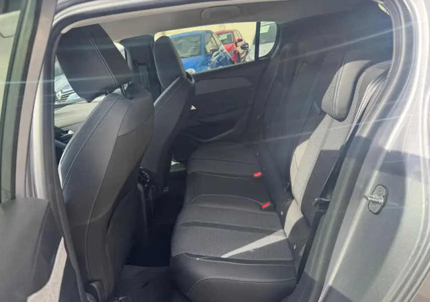 Vue intérieure côté droit des sièges arrière gris foncé de la Peugeot 308 Hybrid 145 e-DCS6 Allure 2025.